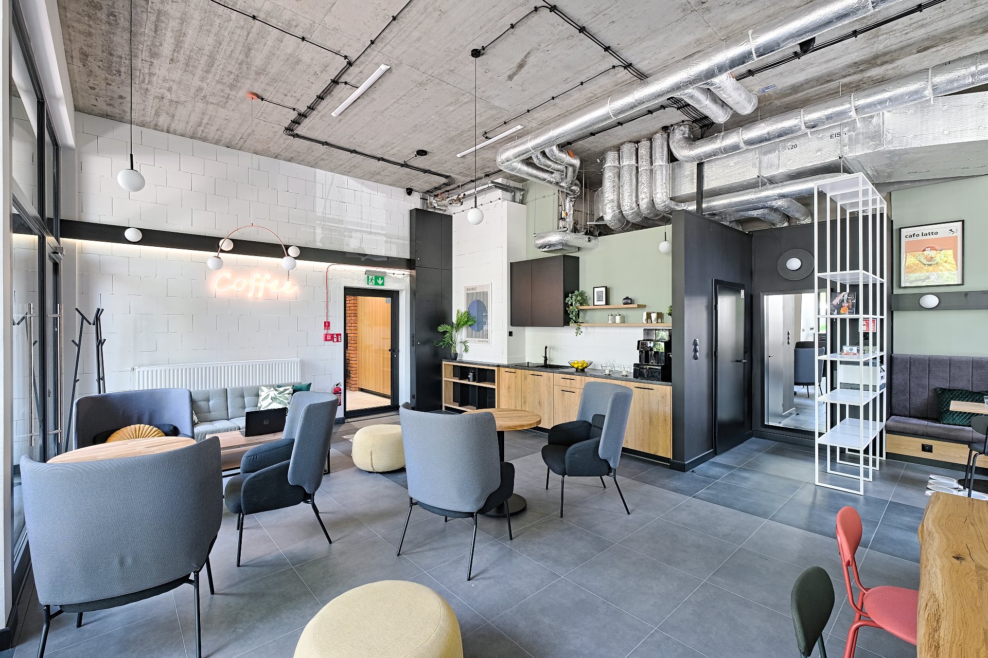 Club Room at La Praga — co-working area with armchairs and tables